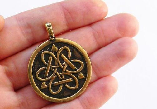 Amulet coin of luck from poverty in hand